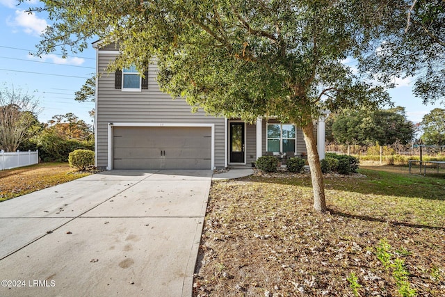 view of front of house with a garage and a trampoline