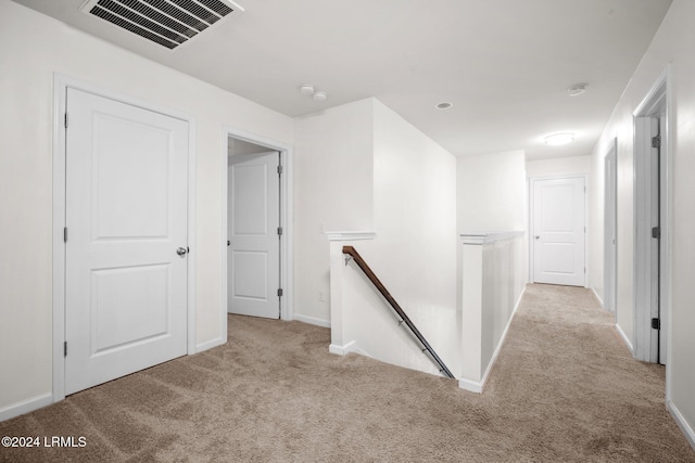 corridor with light colored carpet