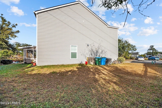 view of property exterior with a lawn