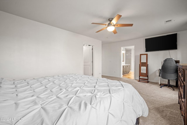 carpeted bedroom with ceiling fan and ensuite bathroom