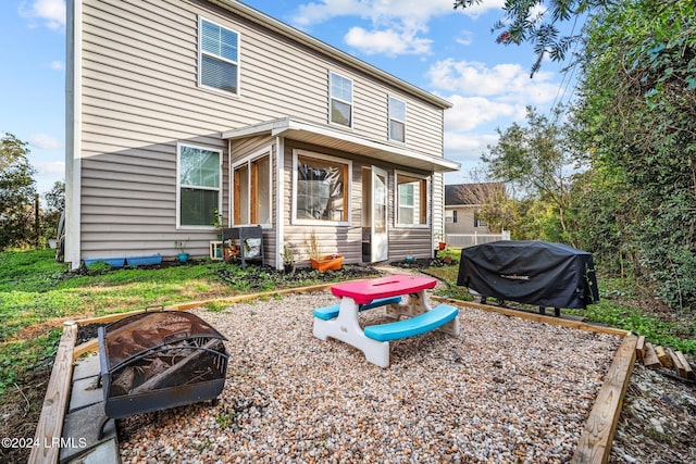 back of property with a fire pit