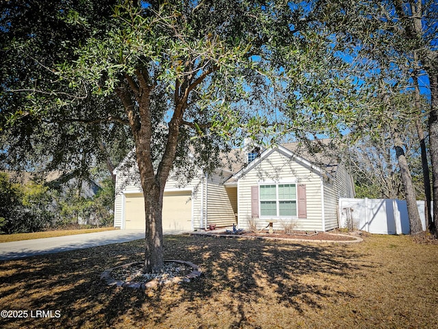 view of front of property with driveway, a garage, and fence