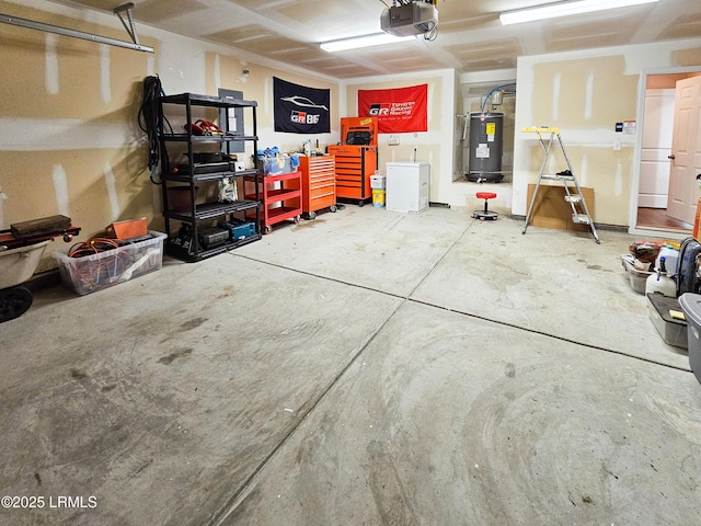 garage featuring a garage door opener and electric water heater