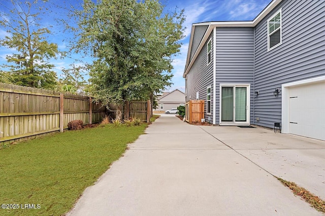 3614 Oyster Bluff Dr, Beaufort, SC 29907 - view of yard featuring a patio area, concrete driveway, and fence