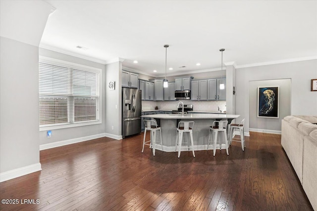 3614 Oyster Bluff Dr, Beaufort, SC 29907 - kitchen with gray cabinetry, light countertops, a kitchen breakfast bar, stainless steel appliances, and a sink
