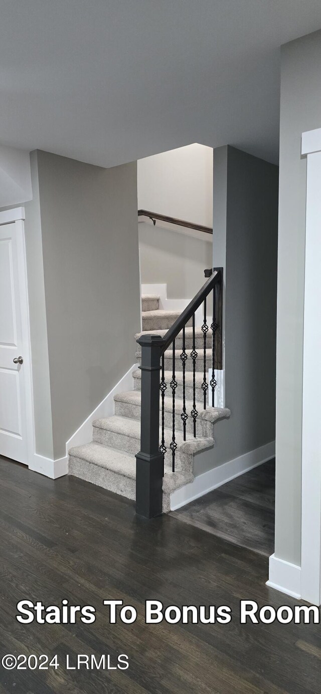 stairs with hardwood / wood-style flooring