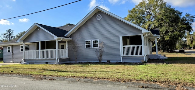 view of property exterior featuring a porch and a yard