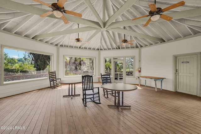 sunroom / solarium with vaulted ceiling with beams