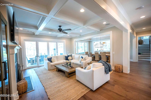 living room with hardwood / wood-style flooring, ceiling fan, beam ceiling, coffered ceiling, and french doors