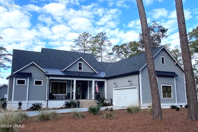 view of front of property with a garage and covered porch