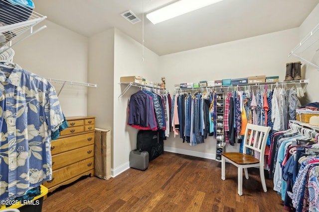 spacious closet featuring visible vents and wood finished floors