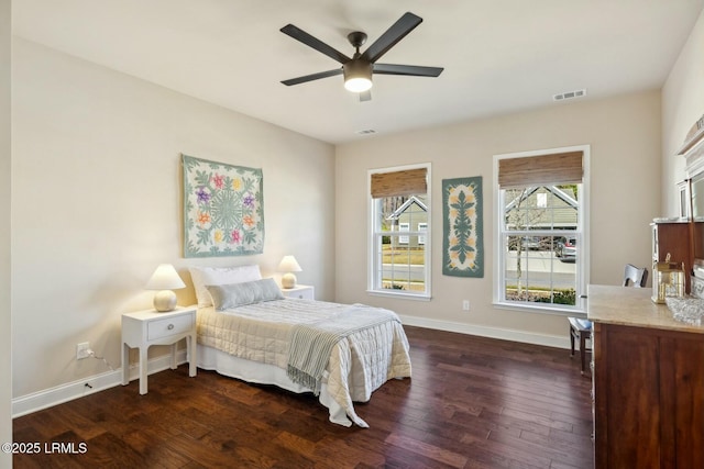 bedroom with visible vents, a ceiling fan, baseboards, and dark wood-style flooring