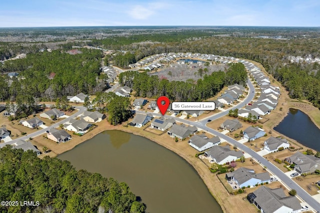 birds eye view of property with a residential view and a water view