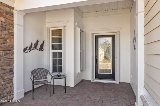 entrance to property featuring brick siding