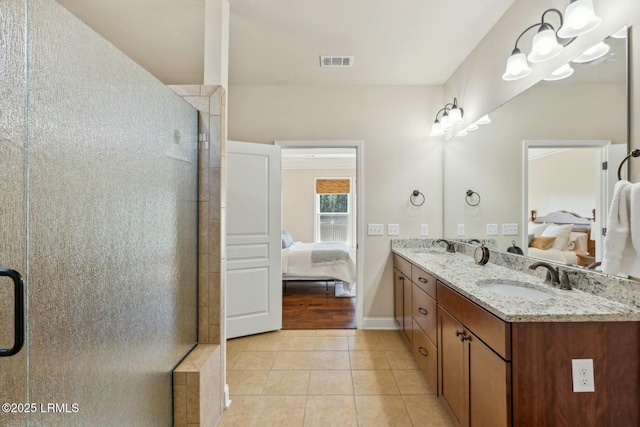 bathroom with a shower stall, tile patterned floors, ensuite bathroom, and a sink