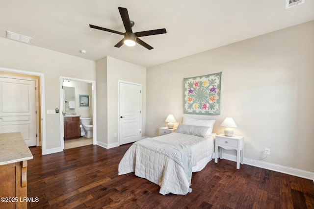 bedroom with baseboards, visible vents, dark wood-style flooring, and connected bathroom