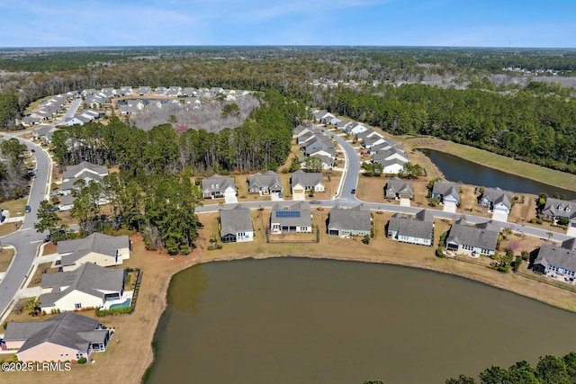 aerial view featuring a residential view, a forest view, and a water view