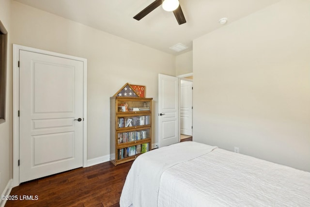 bedroom with baseboards, a ceiling fan, and dark wood-style flooring