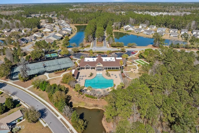 drone / aerial view with a water view and a wooded view