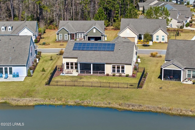 drone / aerial view with a water view and a residential view