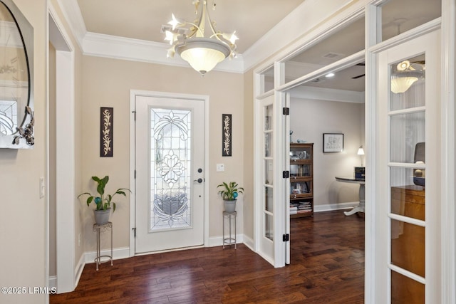 entrance foyer with crown molding, an inviting chandelier, and wood finished floors