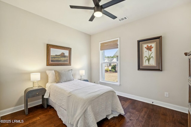 bedroom featuring dark wood-type flooring, baseboards, and visible vents