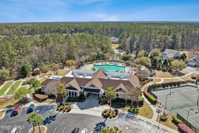 drone / aerial view featuring a wooded view