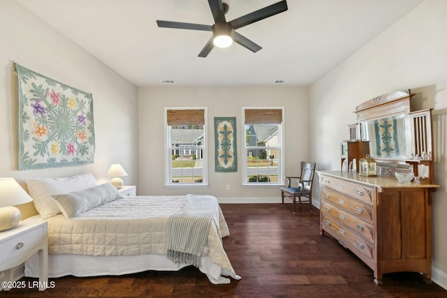 bedroom featuring visible vents, baseboards, and dark wood-style floors