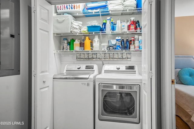 washroom featuring laundry area, electric panel, and separate washer and dryer