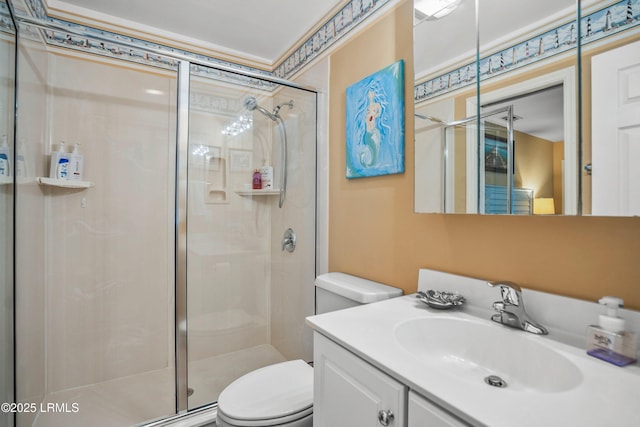 bathroom with a stall shower, vanity, and toilet