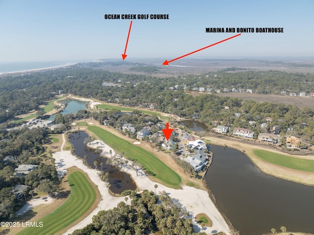 bird's eye view featuring a water view, golf course view, and a view of trees