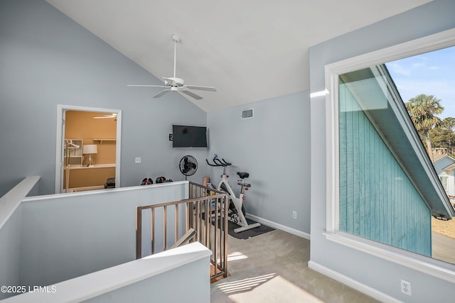 workout area with baseboards, visible vents, lofted ceiling, ceiling fan, and carpet flooring