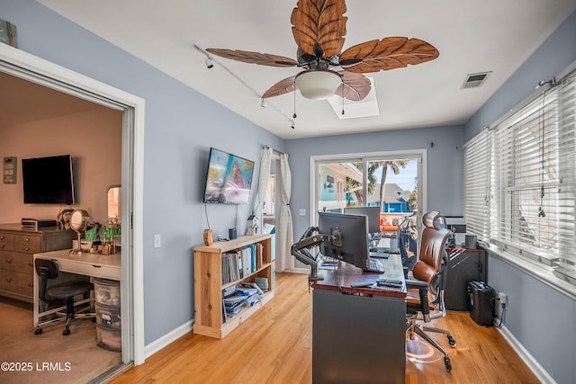 office area featuring visible vents, ceiling fan, baseboards, and wood finished floors