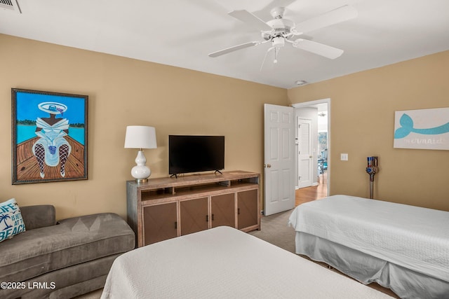 bedroom with carpet floors, visible vents, and a ceiling fan