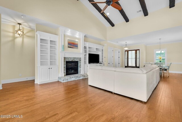 222 Hampton Lake Dr, Bluffton, SC 29910 - living area with a fireplace, baseboards, ceiling fan, lofted ceiling with beams, and light wood-style flooring