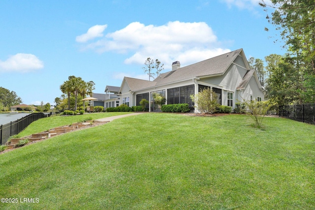 222 Hampton Lake Dr, Bluffton, SC 29910 - exterior space with fence, a sunroom, a chimney, and a lawn