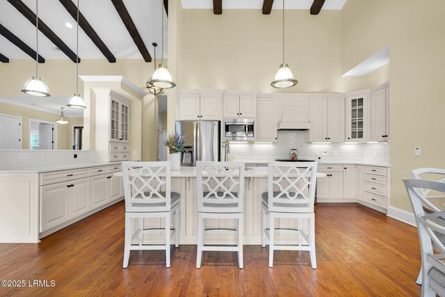222 Hampton Lake Dr, Bluffton, SC 29910 - kitchen with glass insert cabinets, a kitchen bar, white cabinets, tasteful backsplash, and stainless steel appliances