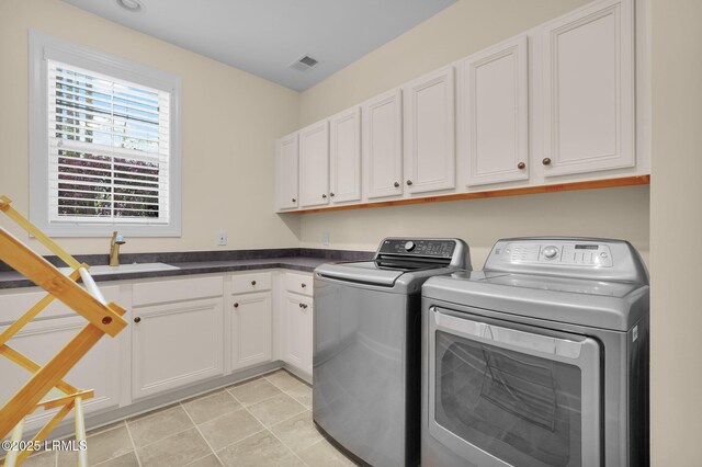 222 Hampton Lake Dr, Bluffton, SC 29910 - laundry area featuring independent washer and dryer, visible vents, cabinet space, a sink, and light tile patterned floors