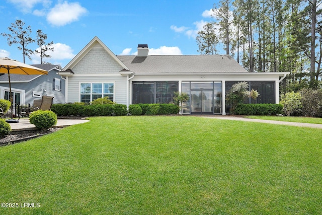222 Hampton Lake Dr, Bluffton, SC 29910 - rear view of property with a sunroom, a lawn, roof with shingles, and a chimney