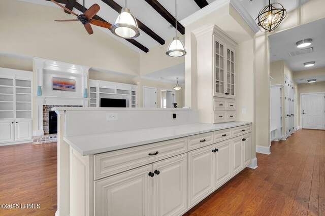 222 Hampton Lake Dr, Bluffton, SC 29910 - kitchen featuring visible vents, wood finished floors, a fireplace, glass insert cabinets, and open floor plan
