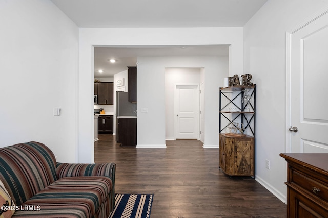 living area with recessed lighting, baseboards, and dark wood-style flooring