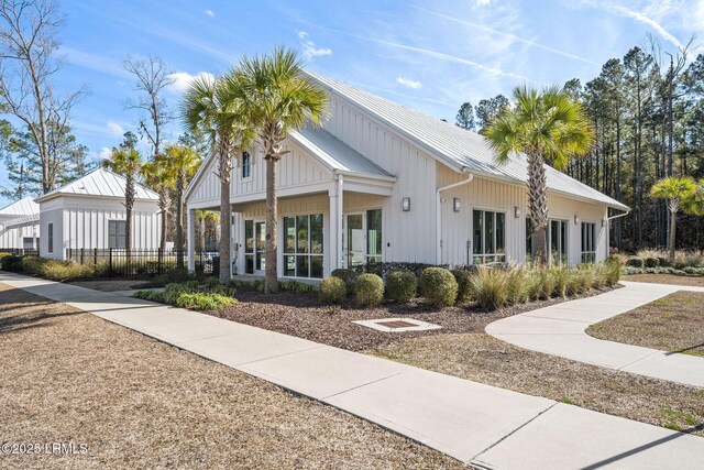 exterior space with fence and metal roof