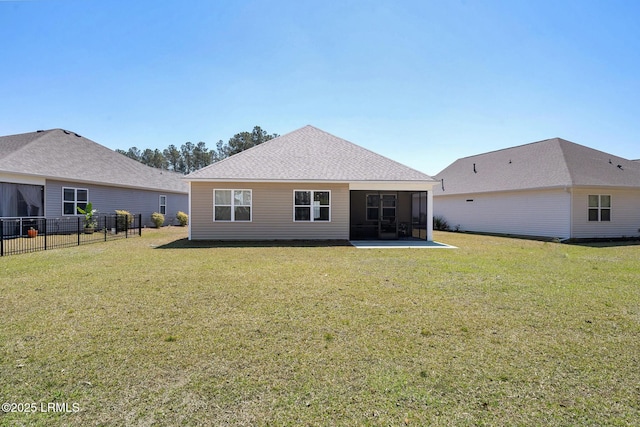 back of house with a yard, fence, a patio area, and a sunroom