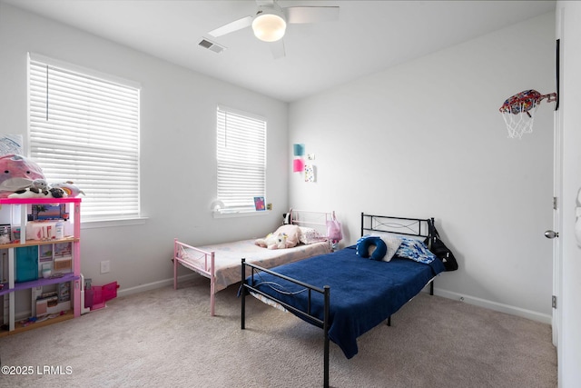 bedroom featuring carpet flooring, baseboards, visible vents, and ceiling fan