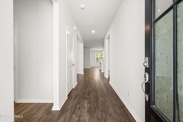 corridor with recessed lighting, baseboards, and dark wood-style floors