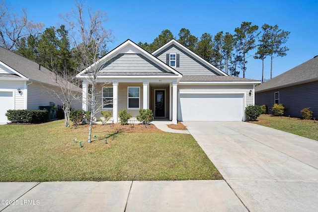 craftsman-style home with a garage, a front lawn, covered porch, and driveway