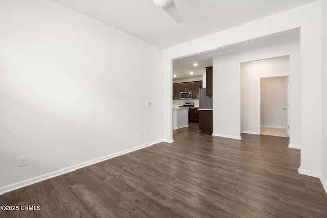 unfurnished living room featuring recessed lighting, a ceiling fan, dark wood finished floors, and baseboards