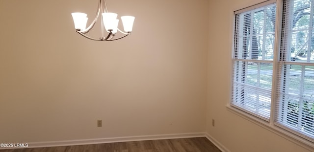 82 Sunset Blvd, Beaufort, SC 29907 - unfurnished room featuring a chandelier, wood finished floors, and healthy amount of natural light