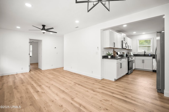 1117 Old Trail Rd, Beaufort, SC 29902 - kitchen with stainless steel appliances, open floor plan, dark countertops, recessed lighting, and light wood-style flooring