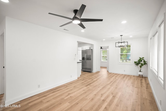 1117 Old Trail Rd, Beaufort, SC 29902 - unfurnished living room with ceiling fan, light wood-style floors, a chandelier, recessed lighting, and baseboards